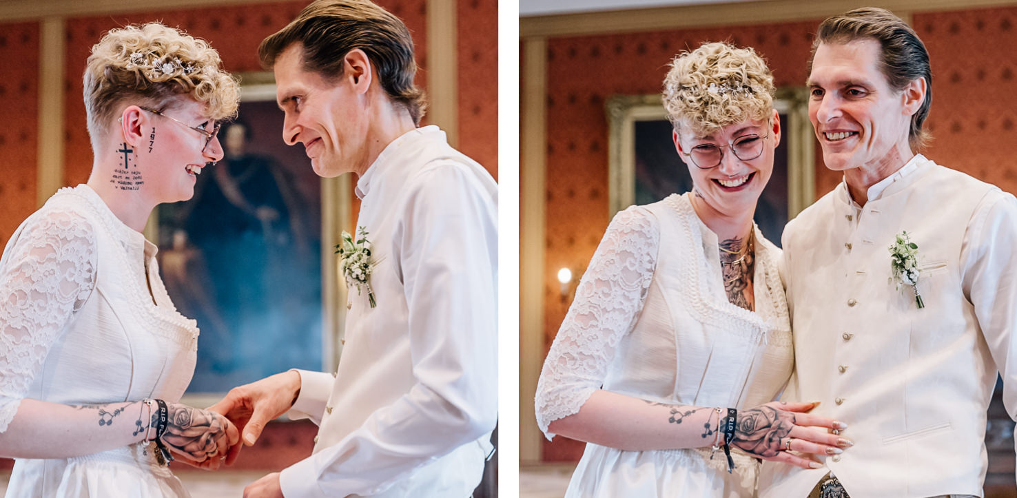 Das Bild zeigt zwei lächelnde Personen in Hochzeitskleidung, die offenbar eine Zeremonie haben oder gerade hatten.