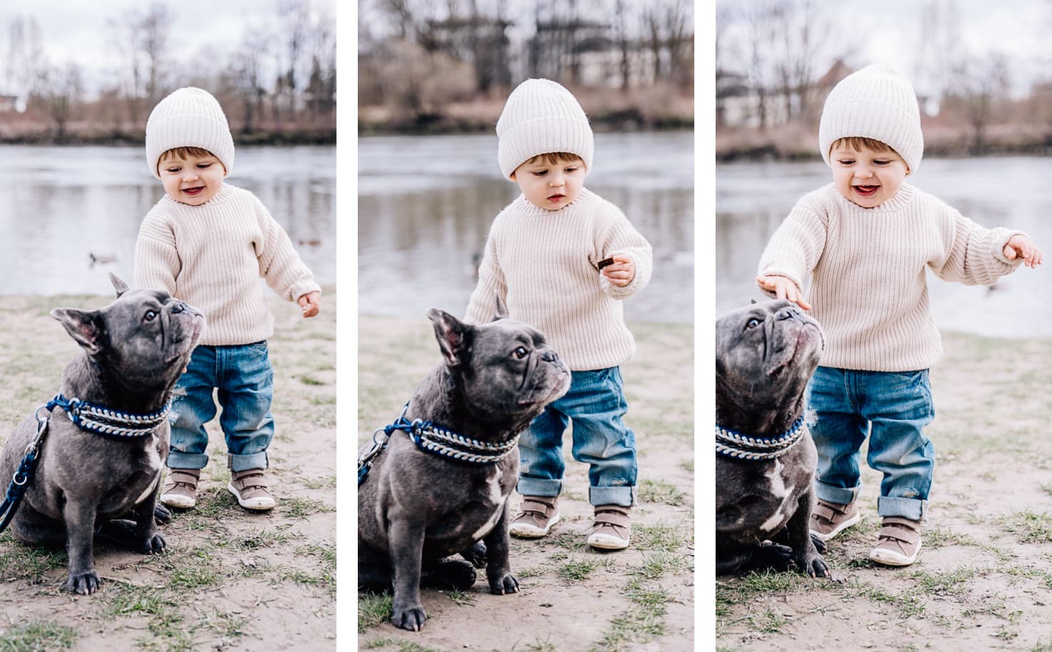 Ein kleines Kind interagiert fröhlich mit einem Hund am Ufer eines Gewässers.